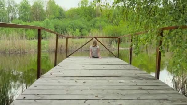 Teen Girl Sitting Wooden Bridge River — Stock Video