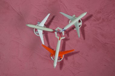 Pembe arka planda oyuncak uçaklar