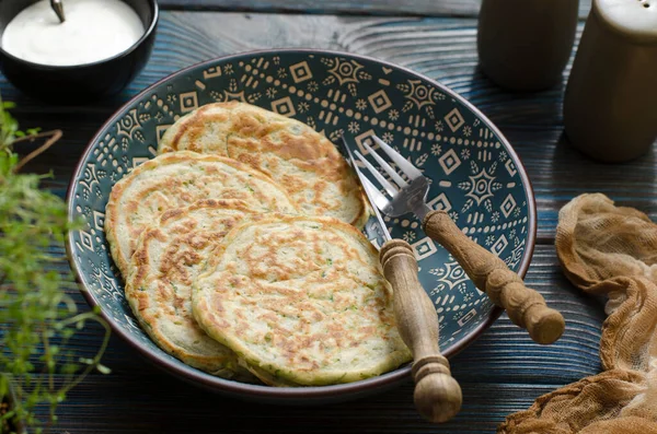 Zucchini pancakes with thyme and sour cream