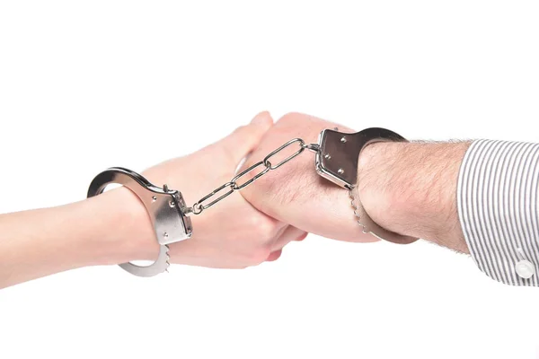 Metal handcuffs on the hands of men and women. — Stock Photo, Image