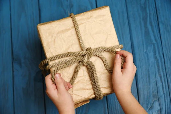 Children Hands Hold Gift Flatlay Blue Wood Background — Stock Photo, Image