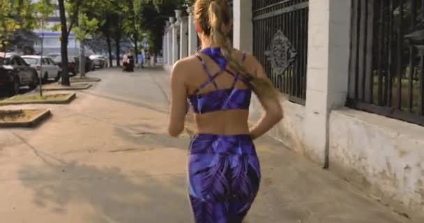 Woman running in city, back view — Stock Video