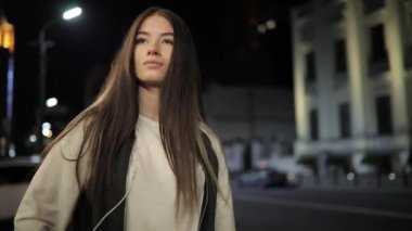 Şehir merkezinde müzik ve rahatlatıcı gece city adlı yürüyen yalnızlık kadın