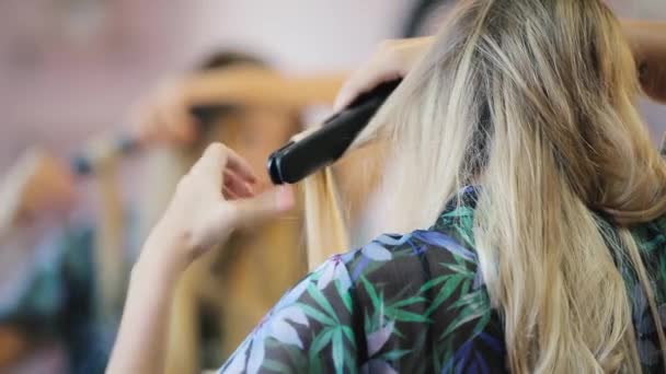 Frau kräuselt ihre Haare mit einem Lockenstab — Stockvideo