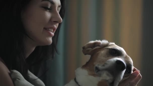 Woman embracing her dog in home closeup — Stock Video