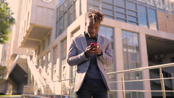 Успішний молодий бізнесмен дивиться чудові новини по телефону — стокове відео
