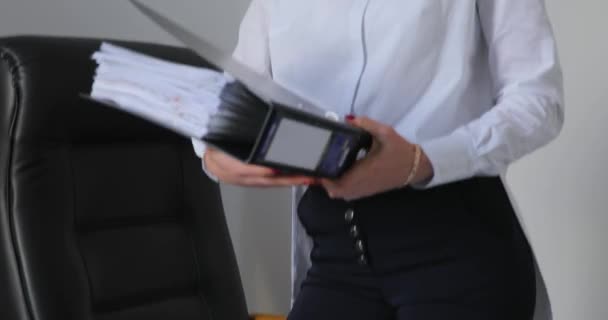 Businesswoman, young office worker searching a information in a folder — Stock Video