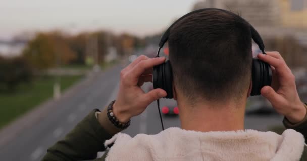 Vista Trasera Del Hombre Escuchando Una Música Auriculares Puente Ciudad — Vídeos de Stock