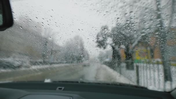 Windshield wipers claaning car window at winter — Stock Video