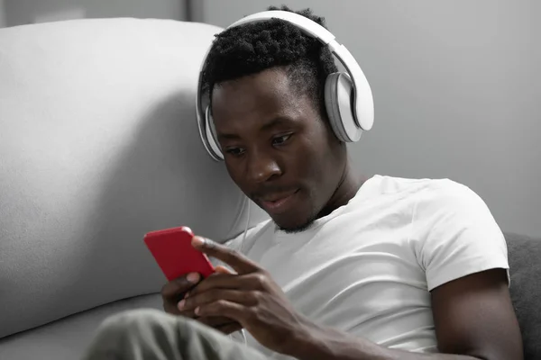 African man listening to music at home