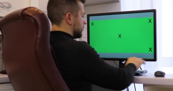 Man Menggunakan Komputer Dengan Layar Hijau Kroma Kunci Rumah — Stok Video