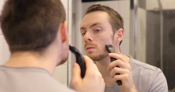 Man Shaving Face Trimmer Looking Mirror Bathroom — Stock Video