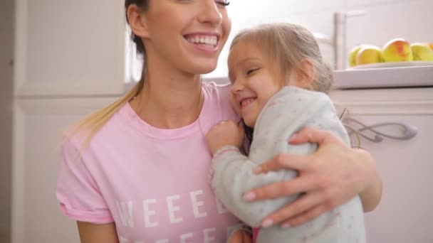 Daughter and her mother hug at home in slow motion — Stock Video