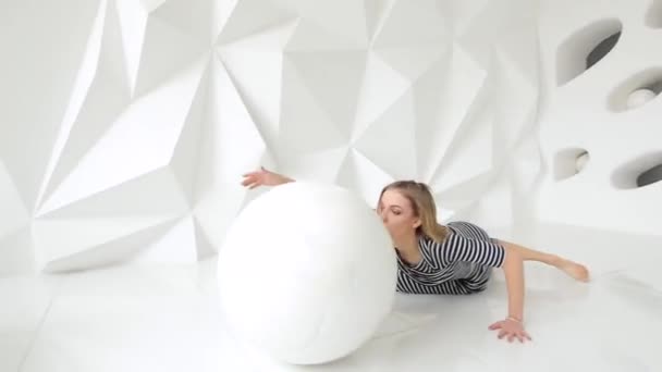 Young woman performing contemporary dance moves in white studio with ball — Stock Video