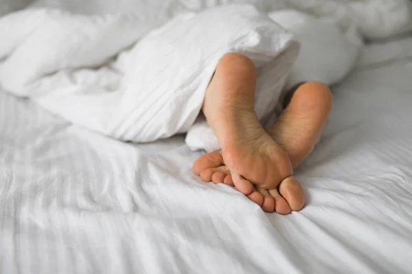 Male Feets White Bed Sheet — Stock Photo, Image
