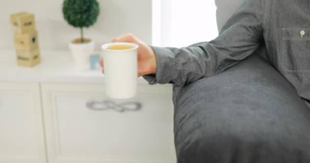 Anonymous man drinking tea at home — Stock Video