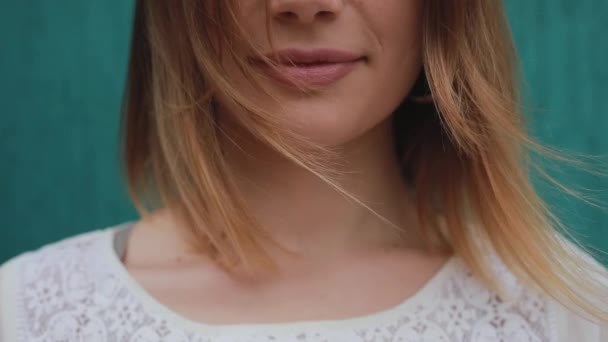 Closeup portrait of wind blows woman hair — Stock Video