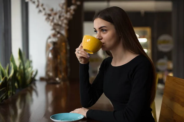 Woman having coffee break sitting in cafe