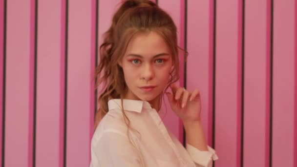 Chica posando cerca de pared rosa — Vídeo de stock