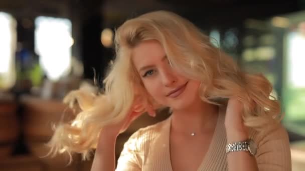 Sexy mujer atractiva tocando el pelo sentado en la cafetería mirándome, coqueteando y coqueteando — Vídeos de Stock