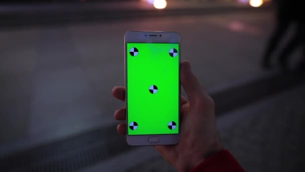 Vue à la 1ère personne, en utilisant l'écran vierge du smartphone assis dans la ville de nuit, maquette 