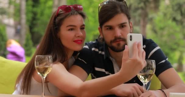 Cita en pareja, hombre y mujer hacen selfie sentado en la mesa — Vídeos de Stock