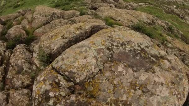 POV, man tourist hiking at rock hill looking around with raised hand — Stock Video