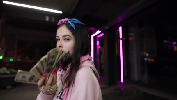 Rich girl play with money at night city — Stock Video