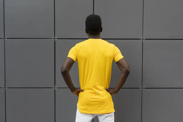 Empty blank yellow t-shirt on the american male back