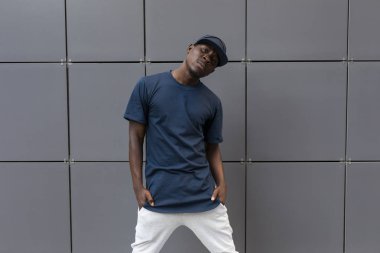 Duvara yakın boş t-shirt ayakta emin Amerikan adam