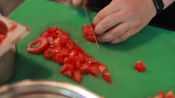 Chef hands cut tomato on a board — Stock Video