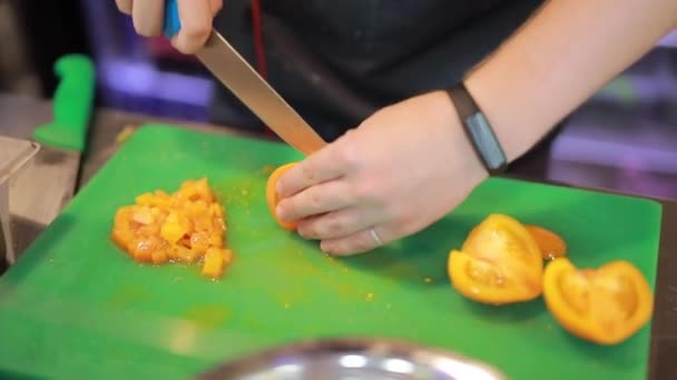 Chef hands cut tomato on a board — Stock Video