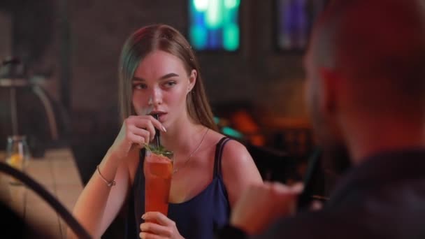 Жінка фліртує з чоловіком в барі — стокове відео