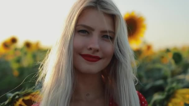 Pretty woman portrait in sunflower field, slow motion — Stock Video