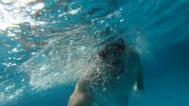 Hombre nadando bajo el agua en la piscina, cámara lenta — Vídeo de stock