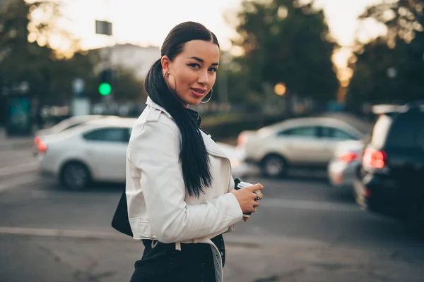 Bella donna in possesso di tazza di caffè di carta e godendo di camminare in città — Foto Stock