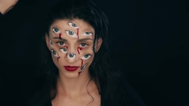 Art Halloween makeup, woman has many eyes on a face — Stock Video