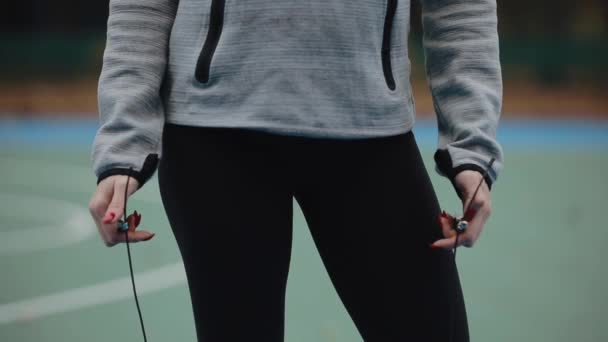 Sport woman holding skipping-rope on a stadium — Stock Video