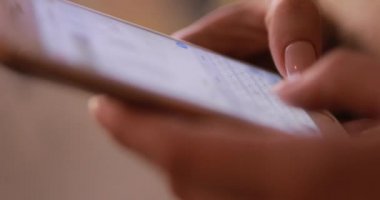 Close up of woman hands texting writing messages on a smartphone
