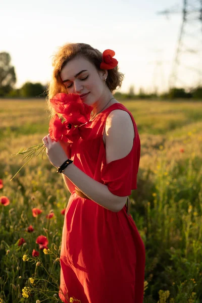 Woman sniff flowers in a poppy field — Stock Photo, Image