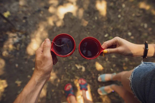 Couple holding cups with tea — Stock Photo, Image