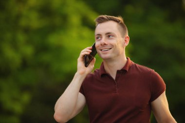 Parkta telefonla konuşan adam.