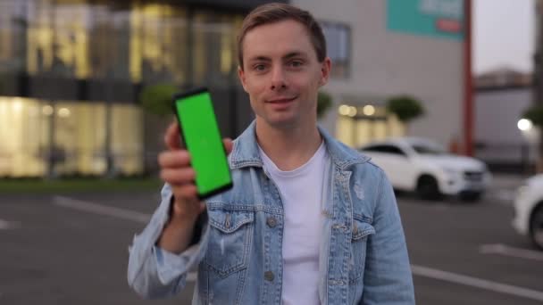 Mężczyzna pokazuje smartfon z zielonym ekranem — Wideo stockowe