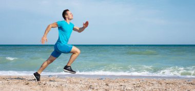 Genç ve hızlı sprinter Okyanus sahilinde koşar