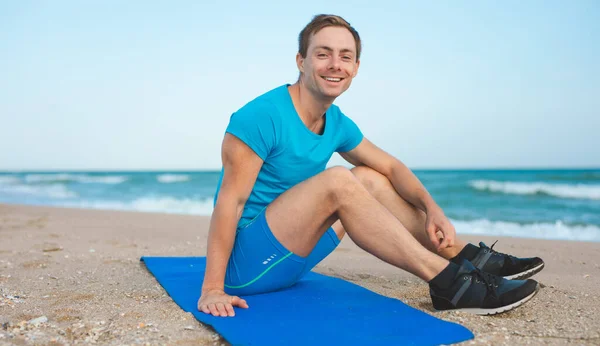 Young Smiling Man Sitting Yoga Mat Beach Stock Picture