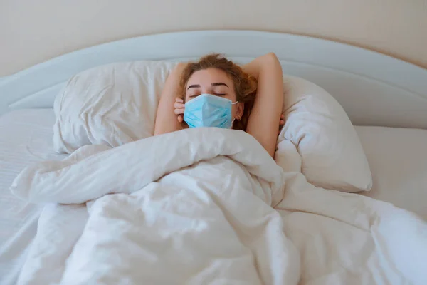 Woman sleep with surgical mask, coronavirus protection, covid-19 concept