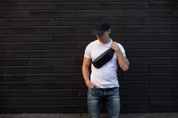 Mockup Man White Shirt Standing Brick Wall Holding Black Waist — Stock Photo, Image
