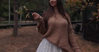 Young woman enjoy fall day walking in autumn park