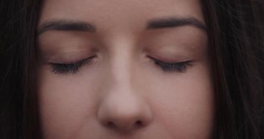 Opening female eyes closeup, slowmotion