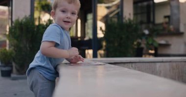 Little naughty boy climbs and crawls everywhere